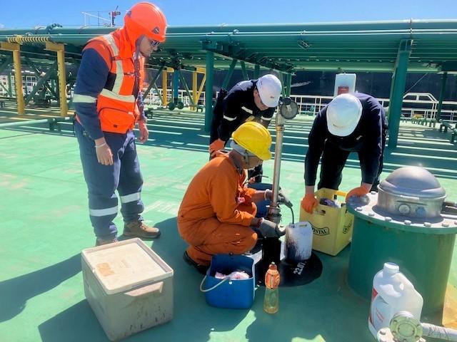 Superintendents sampling cargo on a tanker deck